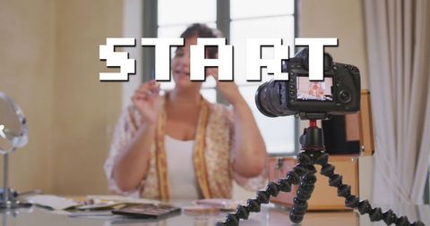 Vlogger filming makeup tutorial behind digital start text
