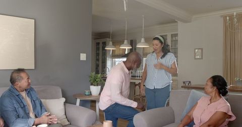 Diverse Seniors Greeting in Cozy Living Room Atmosphere