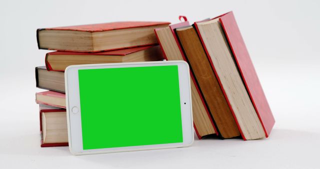 Tablet with Green Screen Next to Stack of Books - Download Free Stock Images Pikwizard.com