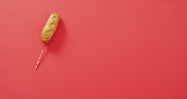 Image of corn dog with mustard on a red surface. food, cuisine and catering ingredients.