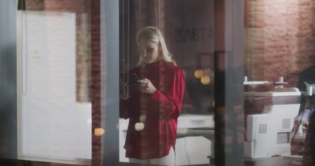 Businesswoman Using Smartphone in Modern Office at Night - Download Free Stock Images Pikwizard.com