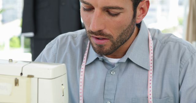 Young Male Tailor Concentrating on Sewing Machine Work - Download Free Stock Images Pikwizard.com