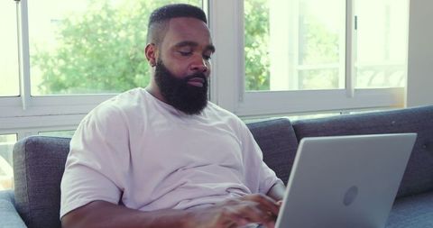 Casual Home Office: Man Working on Laptop on Spring Day