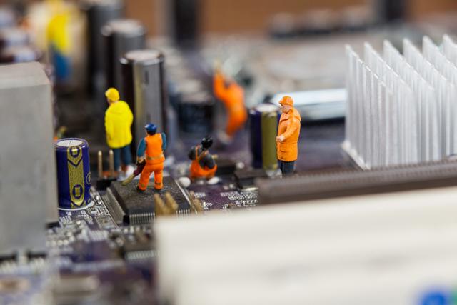 Miniature workers in orange and yellow uniforms are seen repairing and maintaining a motherboard circuit. This conceptual image highlights the intricate and detailed work involved in technology and electronics repair. Ideal for use in articles about technology, engineering, computer hardware, and the tech industry. Can also be used in educational materials to illustrate the complexity of electronic components and the importance of maintenance and repair.