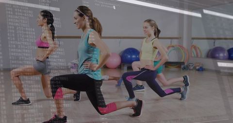 Women lunging in group fitness class with digital code overlay for tech fitness concept