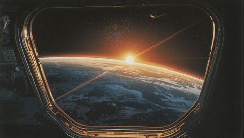 Sunrise Over Earth Framing Through Spacecraft Window Showing Earth Limb and Starfield