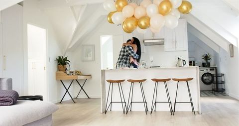 Couple Celebrating Anniversary in Bright Modern Kitchen