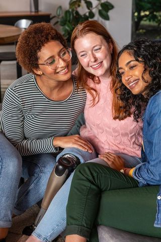 Diverse Friends Lounging on Couch Embracing Inclusivity