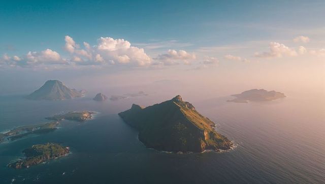 Serene Archipelago with Lush Green Islands During Misty Sunset