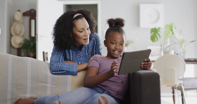 Mother Bonding with Daughter Using Tablet in Living Room - Download Free Stock Images Pikwizard.com