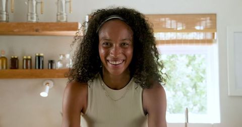 Smiling African American Woman in Cozy Kitchen Environment