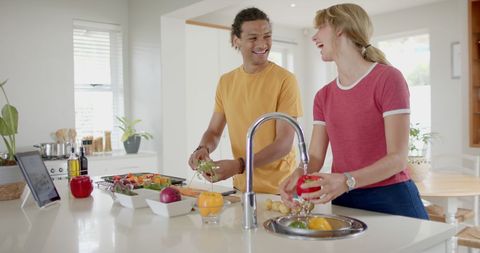 Diverse Couple Preparing Fresh Vegetables in Modern Kitchen