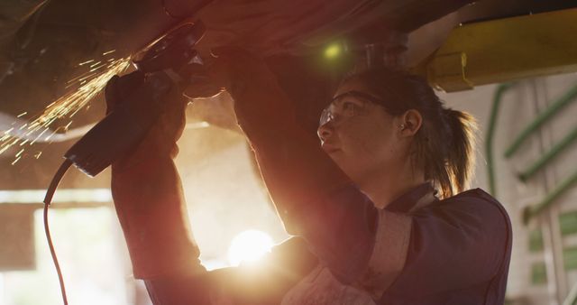 Female Welder Using Angle Grinder with Sparks in Industrial Workshop - Download Free Stock Images Pikwizard.com