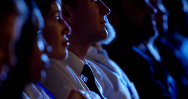 Side view of young Caucasian businessman attending business seminar in auditorium. He is listening lecture 4k