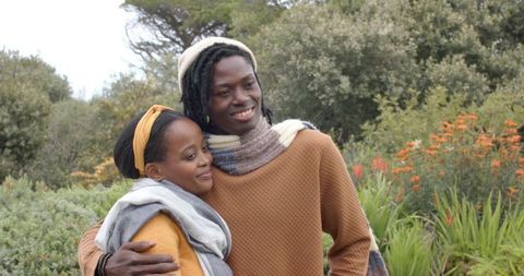 African American Couple Embracing in Garden Wearing Knit Scarves Cozy Mustard Sweater