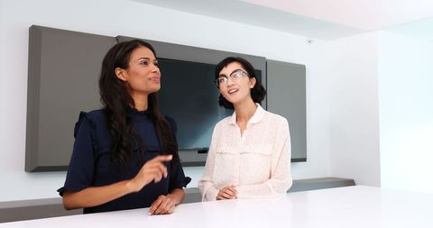 Diverse Professionals Having Creative Discussion in Modern Office Space