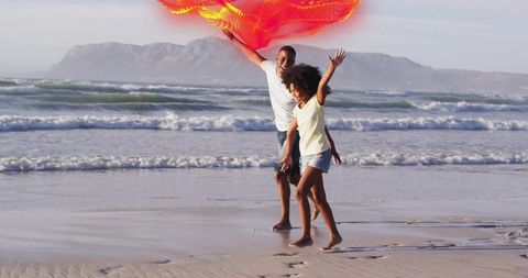 Father and Daughter Play with Kite on the Beach
