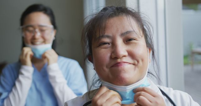 Smiling Healthcare Workers Removing Face Masks Indoors - Download Free Stock Images Pikwizard.com