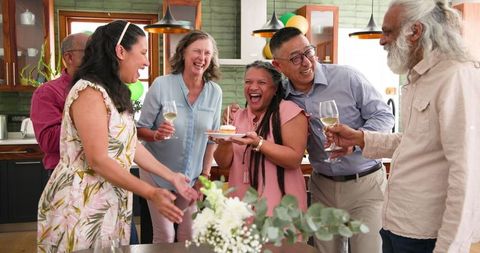 Joyous Birthday Celebration with Diverse Senior Friends Sharing Laughter