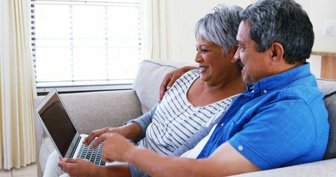Happy Middle-Aged Couple Browsing Laptop Together at Home - Download Free Stock Images Pikwizard.com