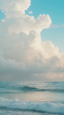 Vertical seascape video: cumulus cloud tower and gentle cresting waves for relaxation