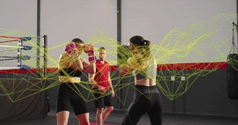 Female boxers sparring with coach in industrial gym with neon mesh motion overlay art