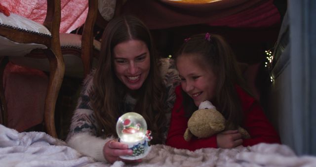 Mother and daughter sharing a magical moment in a cozy makeshift tent - Download Free Stock Images Pikwizard.com