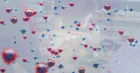 Community cooking workshop showing viral contamination concept with floating virus particles