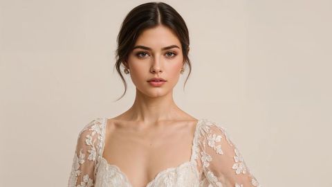 Elegant beautiful lady bride in lace gown with floral details