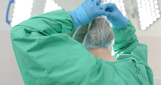 Surgeon Preparing for Surgery with Protective Gloves and Cap - Download Free Stock Images Pikwizard.com