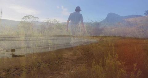 Solitary Hiker Exploring Serene Lake and Mountain Landscape