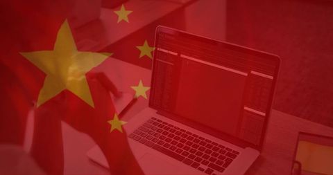 Chinese flag overlaying laptop displaying code symbolizing cybersecurity and surveillance
