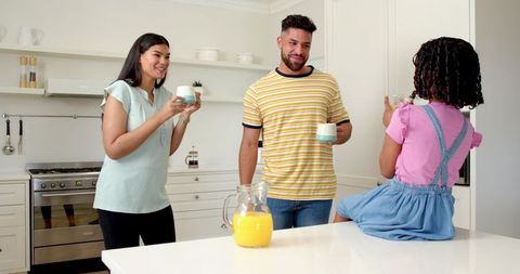 Diverse Family Bonding Over Breakfast in Modern Kitchen