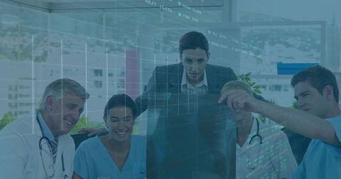 Physician leading medical team reviewing x-ray and patient data in modern clinic office