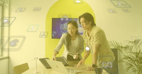 Engineers Collaborating on Renewable Energy Technology in Office