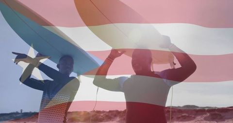 Father and son carrying surfboards under clear sky
