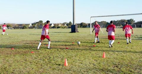 Team passing practice on suburban soccer field