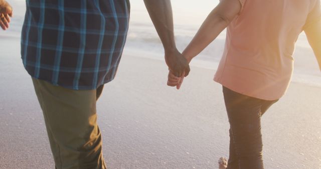 Senior african american couple holding hands and walking on sunny beach - Download Free Stock Photos Pikwizard.com