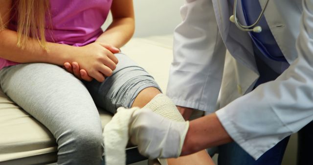 Doctor Wrapping Girl's Knee with Bandage at Medical Clinic - Download Free Stock Images Pikwizard.com