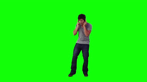 Man Listening to Music with Headphones on Green Screen
