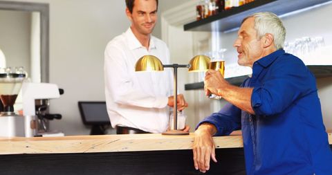 Friendly Exchange Over Drinks in Cozy Restaurant