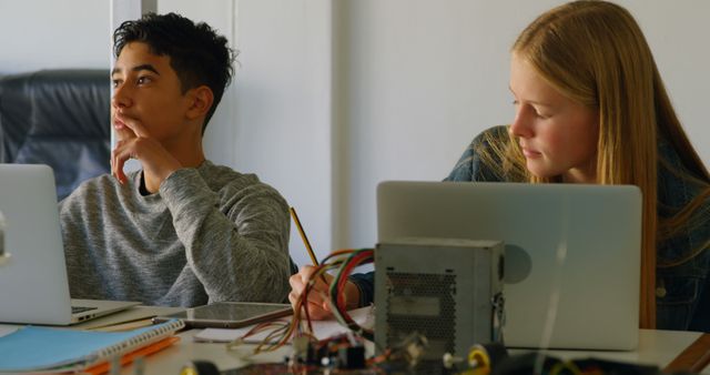 Two Teenagers Working on STEM Project with Laptops and Circuit Board - Download Free Stock Images Pikwizard.com