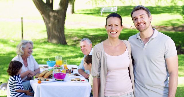 Smiling Family Posing at Outdoor Picnic in Park - Download Free Stock Images Pikwizard.com