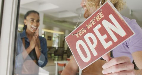 Excited baristas opening coffee shop