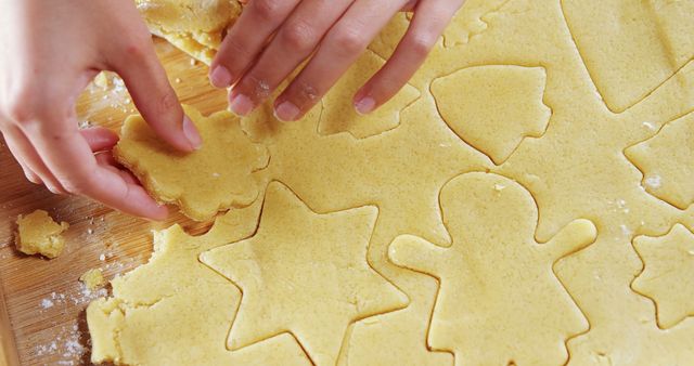 Close-up of woman removing gingerbread dough on wooden table  - Download Free Stock Photos Pikwizard.com