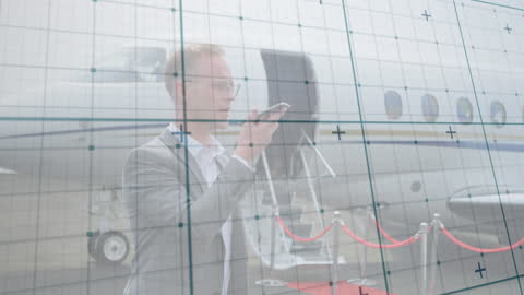 Businessman Using Smartphone with Financial Data Overlay at Airport