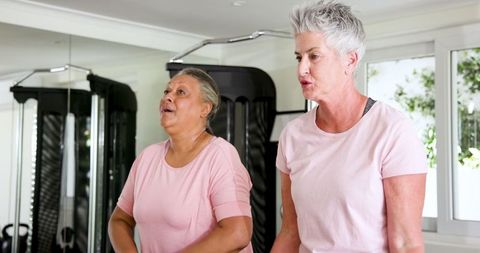Senior Lesbian Couple Joyful Workout at Home Gym