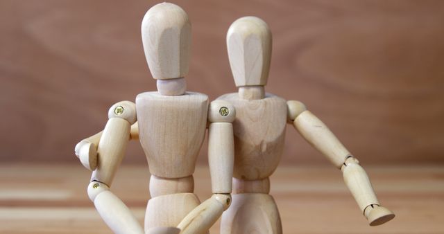 Two Wooden Art Mannequins Pose Together on Wooden Background - Download Free Stock Images Pikwizard.com