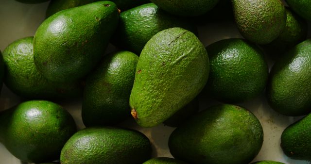 Close-Up of Fresh Green Avocados in Market Basket - Download Free Stock Images Pikwizard.com