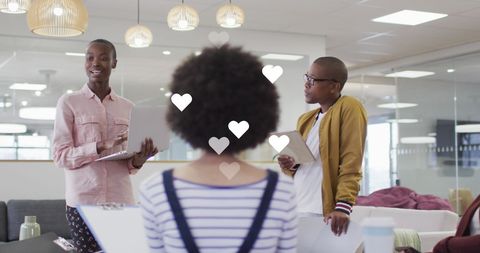 Creative business meeting with diverse team and digital hearts overlay